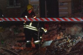 Rescuers are sorting through the rubble of an apartment building in Kharkiv that was destroyed by a Russian missile