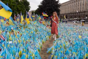 A graduate near the flags in memory of the fallen defenders of Ukraine