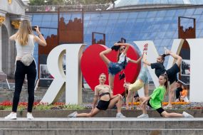 Girls gymnasts take pictures near the "I love Ukraine" sign