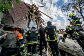 Rescue workers are sorting through the rubble of a house in Kharkiv destroyed by an explosion of Russian ammunition