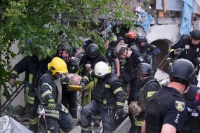 Rescuers take out a 75-year-old man on a medical stretcher from the rubble of a house in Kharkiv