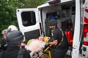 Rescuers take out a 75-year-old man on a medical stretcher from the rubble of a house in Kharkiv