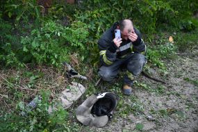 Rescuer rests after sorting through the rubble of a house destroyed by an explosion of Russian ammunition in Kharkiv