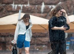 Girls walk in the rain in the center of Kyiv