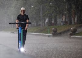 A man on an electric scooter in the center of Kyiv