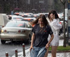 Girls walk in the rain in the center of Kyiv
