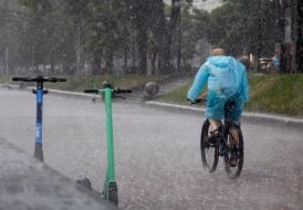 A cyclist in the rain in the center of Kyiv