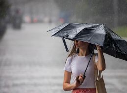 A girl under an umbrella in the center of Kyiv