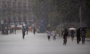 Passersby in the rain in the center of Kyiv