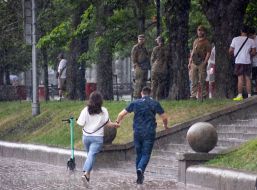 Passersby in the rain in the center of Kyiv