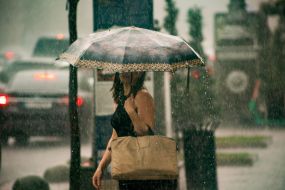 A girl under an umbrella in the center of Kyiv