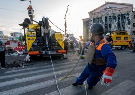 Rescuers work near a destroyed residential building in Kharkiv