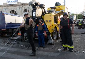 Rescuers work near a destroyed residential building in Kharkiv