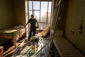 A man in a destroyed apartment in Kharkiv