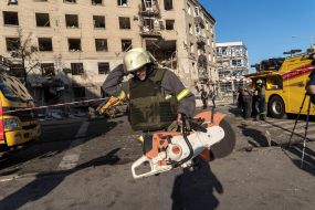 Rescuers work near a destroyed residential building in Kharkiv