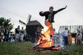 A participant in the celebration of Ivan Kupala jumps over a bonfire in the village of Vytachiv near Kyiv