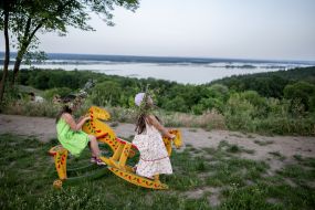 Girls ride on a see-saw