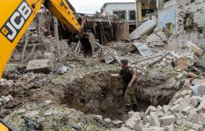 Special equipment rakes away the debris resulting from guided aerial bomb attacks on Kharkiv