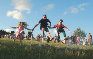 Participants of the Ivan Kupala celebration jump over the fire