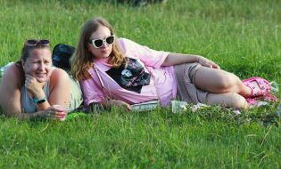 Women are resting on the lawn