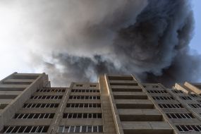 A residential building near warehouses of a retail chain that caught fire as a result of a cruise missile attack in Odesa