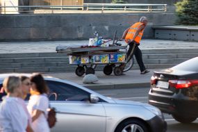 A man transports boxes on a cart in Kyiv