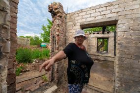 A local resident shows her dilapidated greenhouse