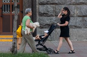 Woman with dog and girl with child