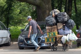 A man carries his goods on a cart