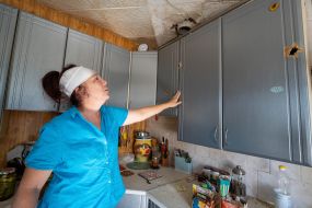 A local resident shows where debris from a Russian bomb hit