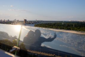 Reflection on the glass of the pedestrian and bicycle bridge across Vladimirsky Spusk