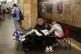 People hide from enemy rockets and mortars at one of the Kyiv metro stations