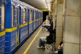 People hide from enemy rockets and mortars at one of the Kyiv metro stations