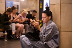 People hide from enemy rockets and mortars at one of the Kyiv metro stations
