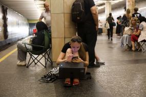 People hide from enemy rockets and mortars at one of the Kyiv metro stations