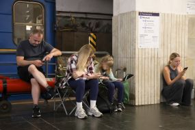 People hide from enemy rockets and mortars at one of the Kyiv metro stations