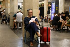 People hide from enemy rockets and mortars at one of the Kyiv metro stations