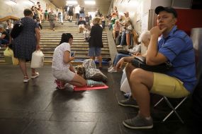 People hide from enemy rockets and mortars at one of the Kyiv metro stations