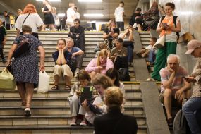 People hide from enemy rockets and mortars at one of the Kyiv metro stations