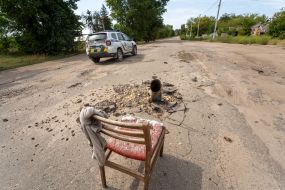 A fragment of a Russian missile stuck in the asphalt on the road