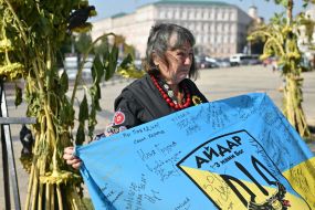 A woman near the Memorial Wall on Mykhailivska Square