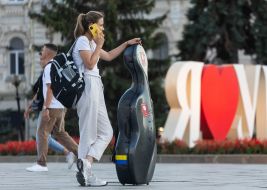 A girl with a musical instrument on Independence Square