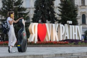 A girl with a musical instrument on Independence Square