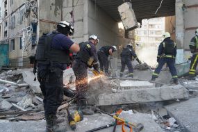 Rescuers are sorting through the rubble of a destroyed residential building in Kharkiv