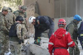 Rescuers are sorting through the rubble of a destroyed residential building in Kharkiv