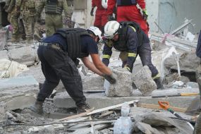 Rescuers are sorting through the rubble of a destroyed residential building in Kharkiv