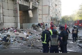 Rescuers are sorting through the rubble of a destroyed residential building in Kharkiv