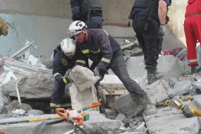 Rescuers are sorting through the rubble of a destroyed residential building in Kharkiv