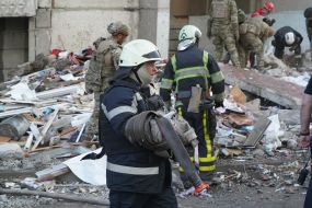 Rescuers are sorting through the rubble of a destroyed residential building in Kharkiv
