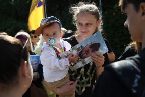 A woman cries near the Wall of Remembrance on Mykhailivska Square